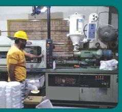 Skilled worker operating plastic moulding plant